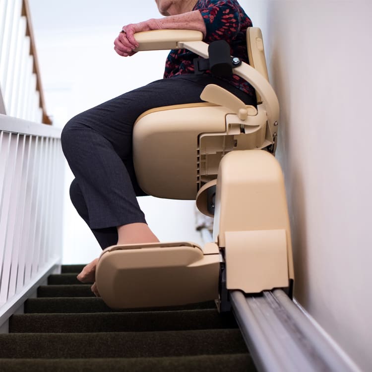 Image of a person going up stair in a stair lift