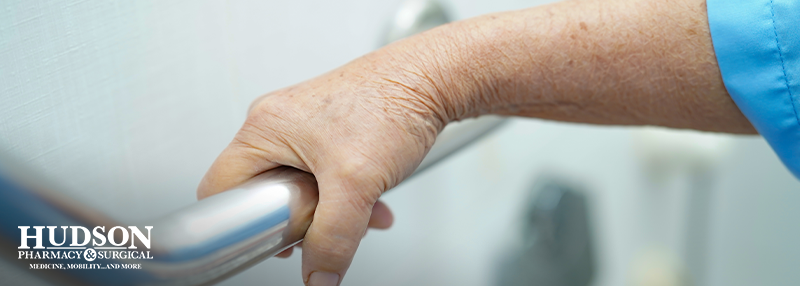 Senior person's hand on a grab bar in the bathroom
