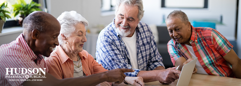 Family of older individuals looking over a checklist at the table together