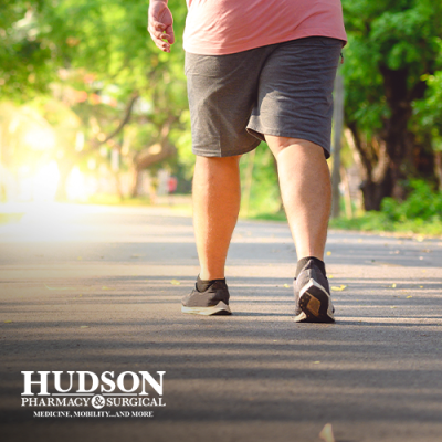 Man walking on a path outdoors with diabetic shoes on