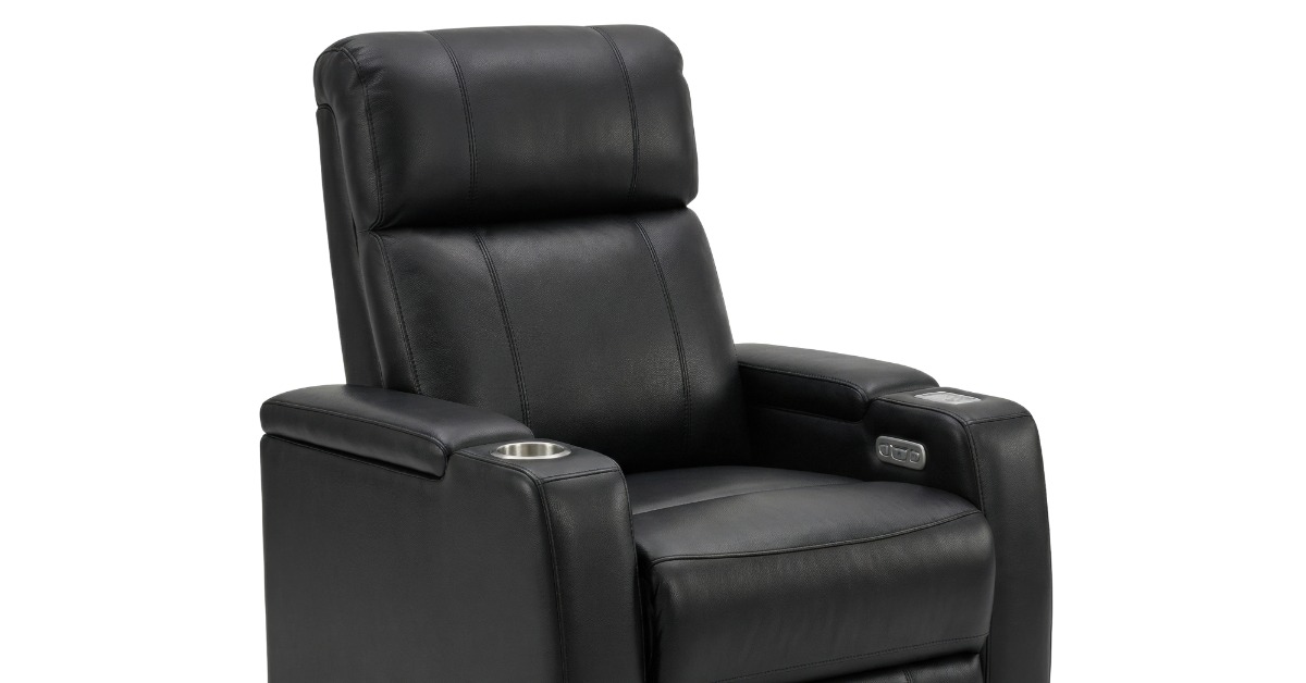 A black leather recliner with cupholders in the art rests. It's in the seated position but lifts at the legs and seat.